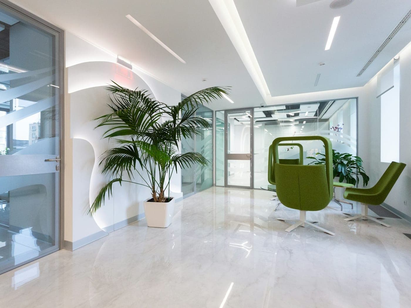Gleaming stone floor in a bright office lobby with plants