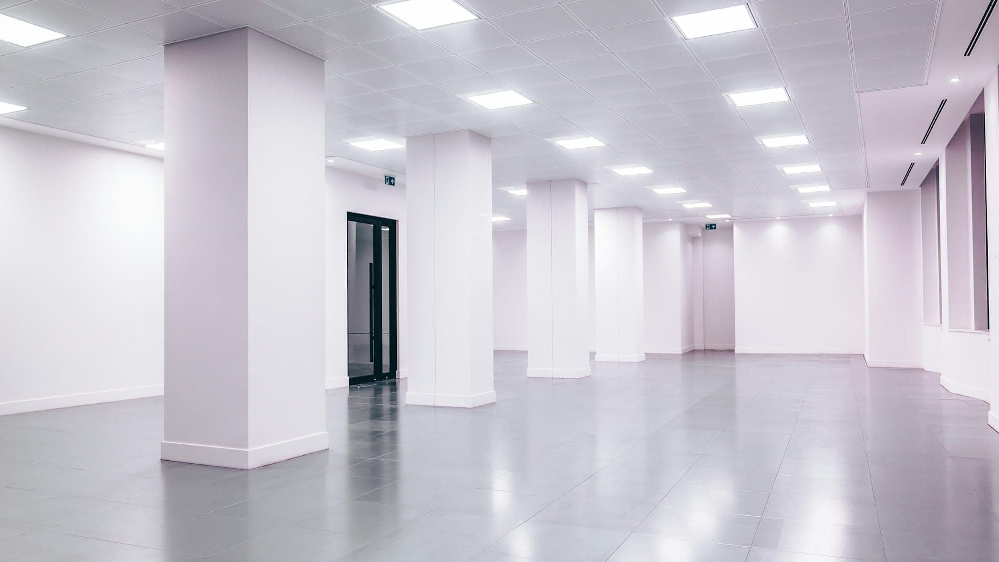 Empty, newly completed space with white walls and a light floor